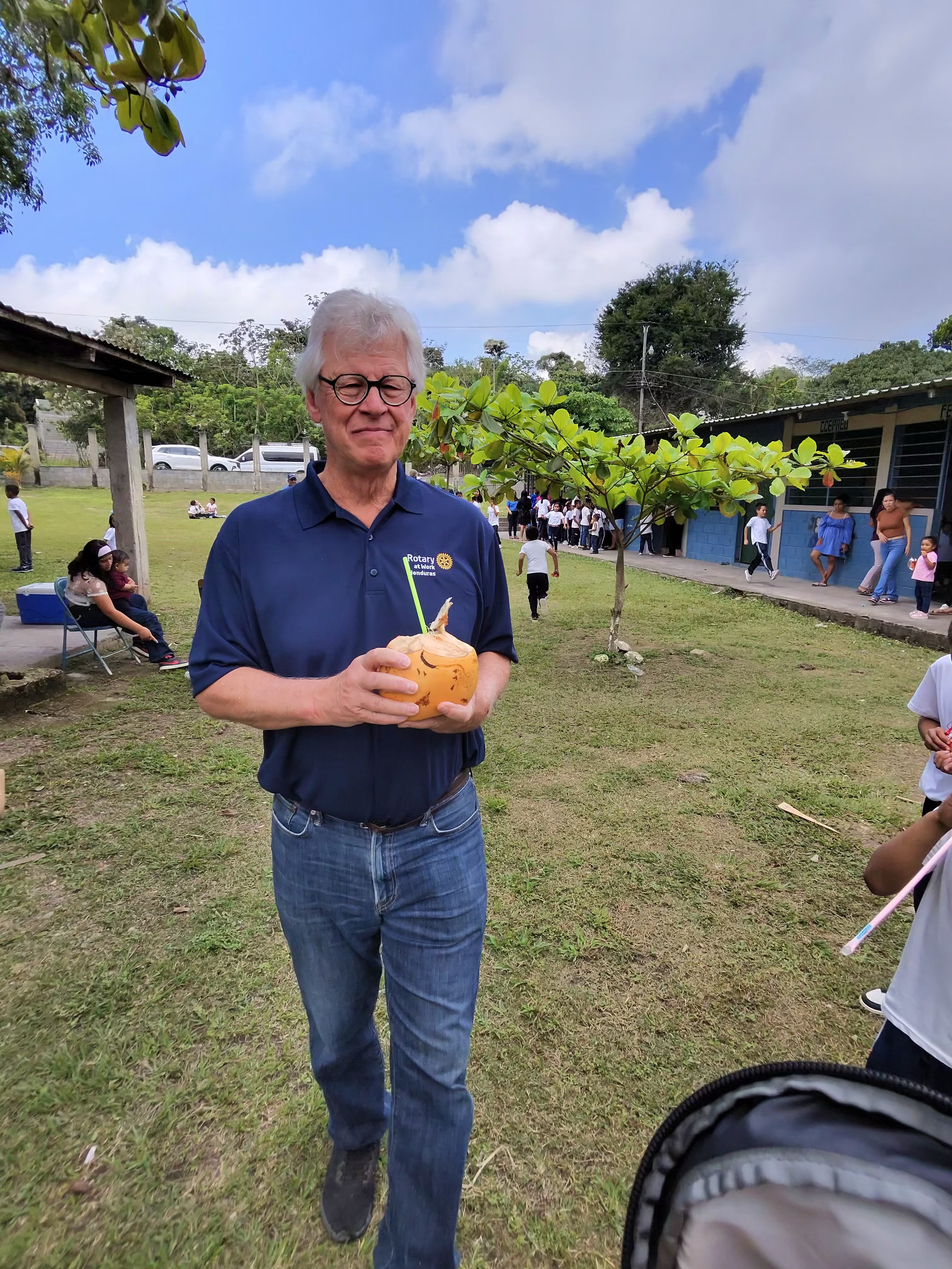 Rotary member in a service polo on a Honduras school campus.
